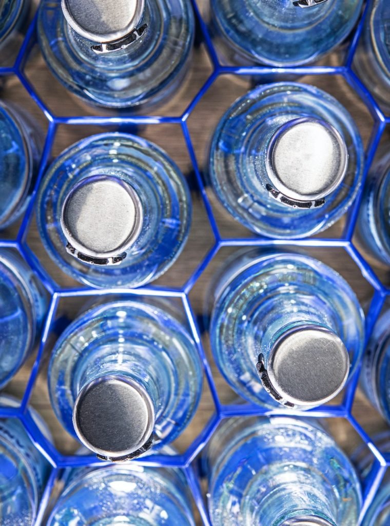 clear-glass-water-bottles-in-holders-.jpg